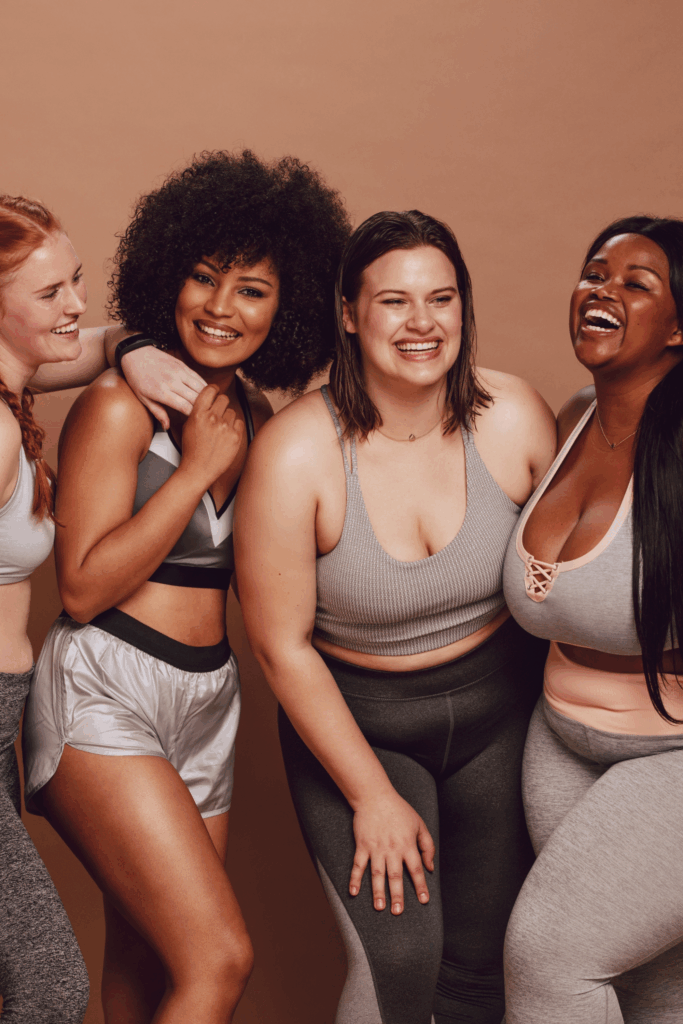 A group of smiling women, showing the beauty of body diversity
