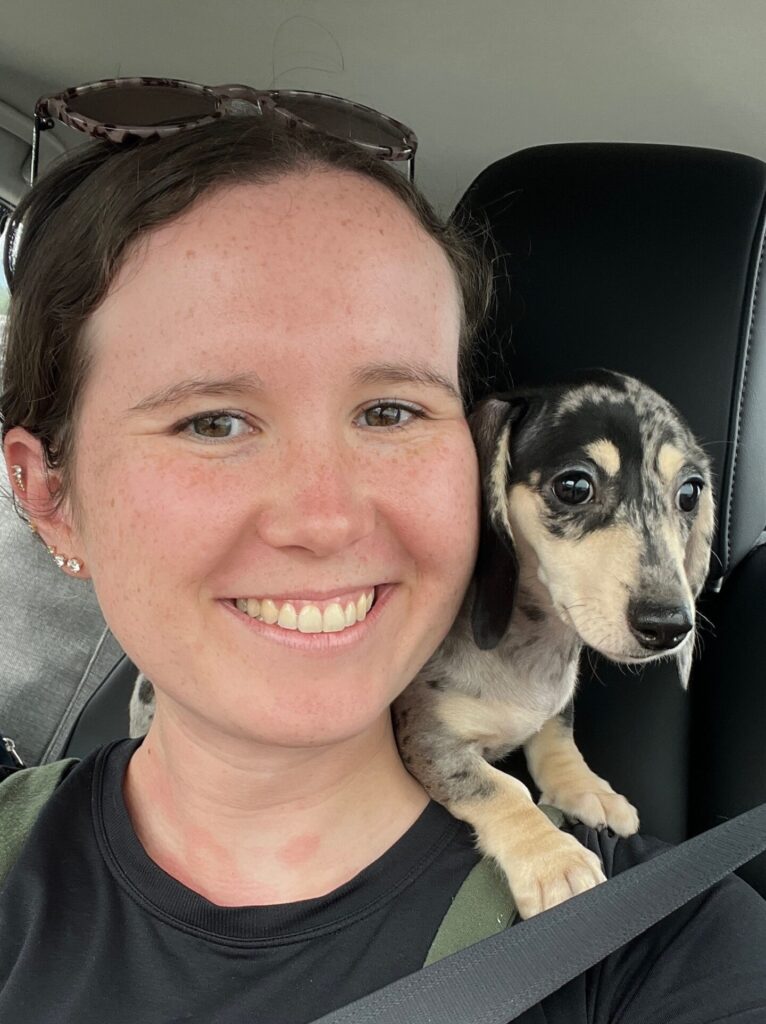 Food freedom dietitian posing with her dog luna on her shoulders