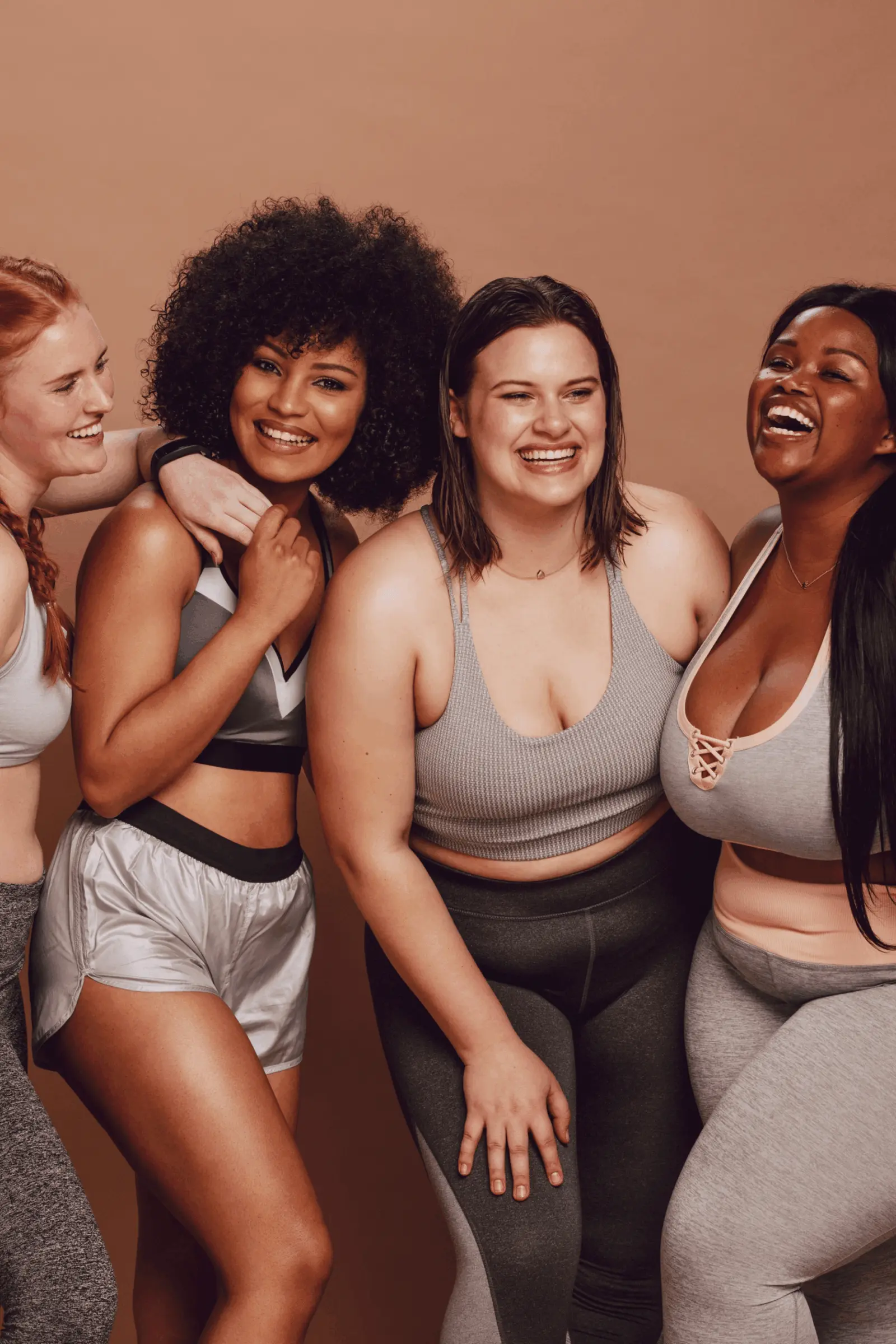 A group of smiling women, showing the beauty of body diversity