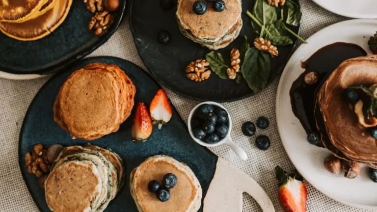 Balanced spread of food with pancakes, fruits, and nuts who created by a Registered Dietitian Nutritionist
