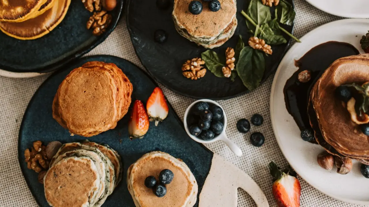 Balanced spread of food with pancakes, fruits, and nuts who created by a Registered Dietitian Nutritionist