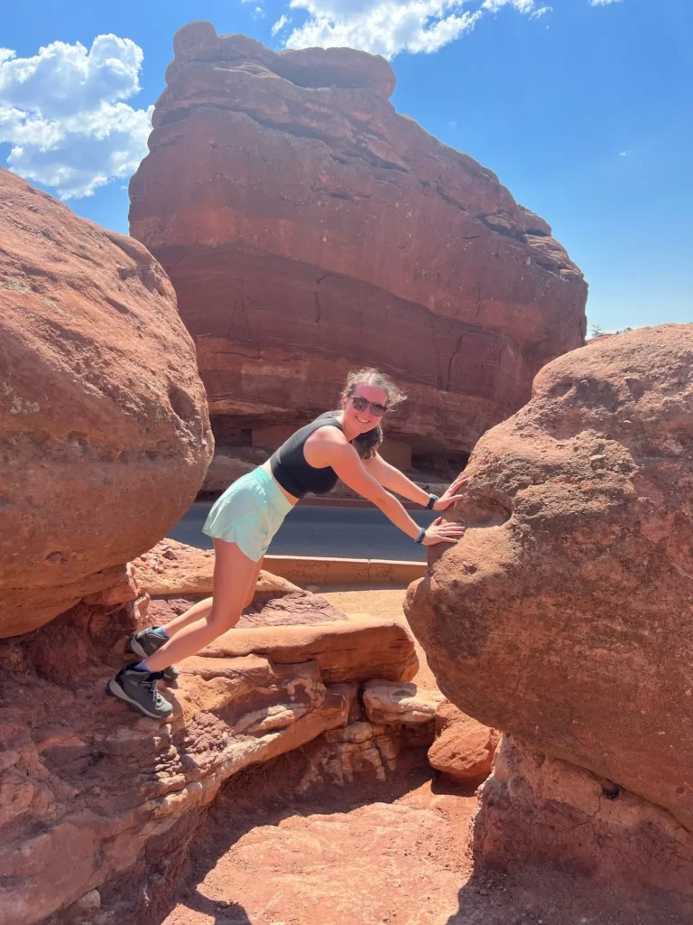Eating Disorder Dietitian Olivia Laughman posing on red rocks in Colorado