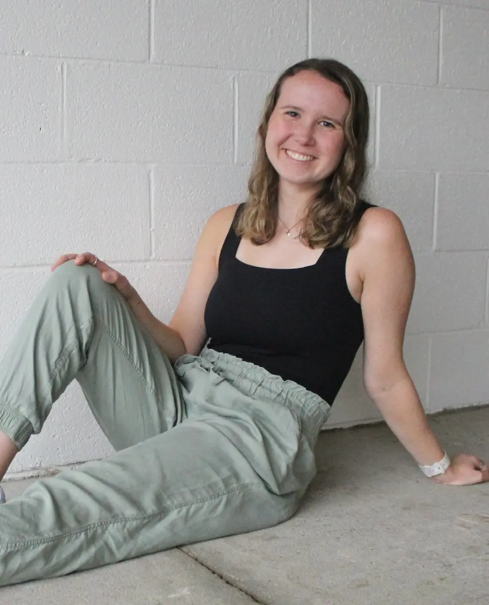 Food Freedom Dietitian, Olivia Laughman, posing in front of a brick wall